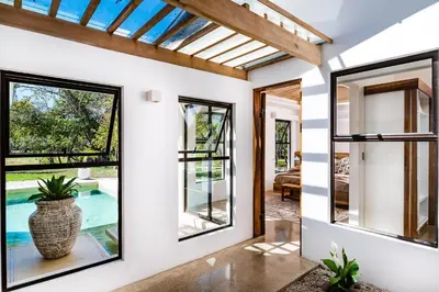 a pivot door in a house with a pool at Casa Cenizaro- 4Br House In Hacienda Pinilla in Tamarindo