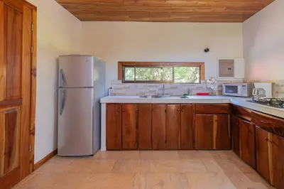 a kitchen with a refrigerator and a sink at Surfside Apartments - Mal Pais in Mal País
