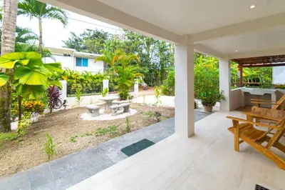 an open patio with benches and a yard with trees at Surfside Apartments - Mal Pais in Mal País