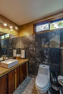 a bathroom with a toilet and a sink at Surfside Apartments - Mal Pais in Mal País