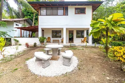 a house with a picnic table in front of it at Surfside Apartments - Mal Pais in Mal País