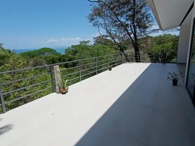 a butterfly sitting on top of a balcony at Laurel Jungle & Ocean in Santa Teresa Beach
