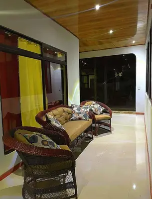 a room with two couches and a couch and windows at Villa El Nido Monteverde in Monteverde Costa Rica