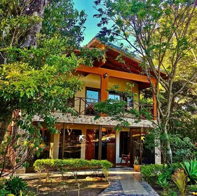 a house in the middle of some trees at Villa El Nido Monteverde in Monteverde Costa Rica