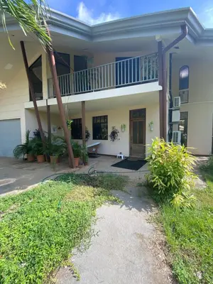 a large house with a porch and a balcony at Villa Pura Vida in Matapalo