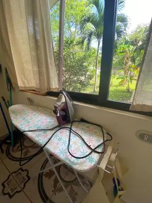 a chair in a room with a window at Villa Pura Vida in Matapalo