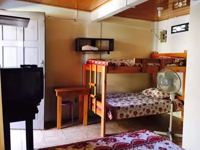 a room with two bunk beds and a desk and a television at Bed and breakfast Bachelor in Sagrada Familia
