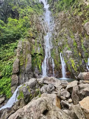 a waterfall on the side of a rocky mountain at Bed and breakfast Bachelor in Sagrada Familia