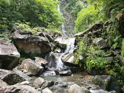 a waterfall in the middle of a river with rocks at Bed and breakfast Bachelor in Sagrada Familia