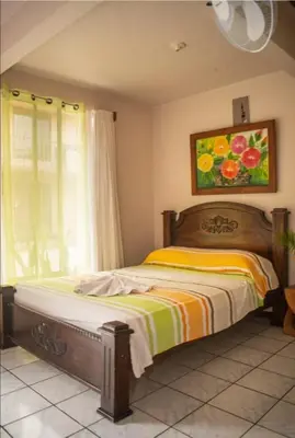 a bedroom with a bed and a painting on the wall at Bed and breakfast Bachelor in Sagrada Familia
