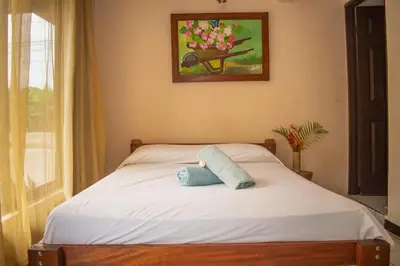 a bed with a pillow sitting on top of it at Bed and breakfast Bachelor in Sagrada Familia