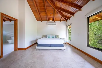 a bedroom with a bed and a bathroom at Casa Carrillo in Buenos Aires