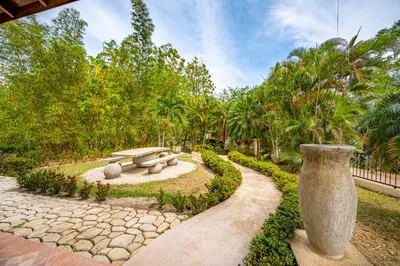 a garden with a bench and trees and a park at Casa Carrillo in Buenos Aires