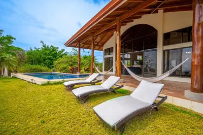 a house with hammocks and a swimming pool at Casa Carrillo in Buenos Aires