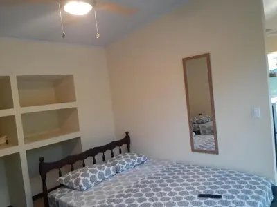 a bedroom with a bed and a mirror at Casa espejo in Potrero