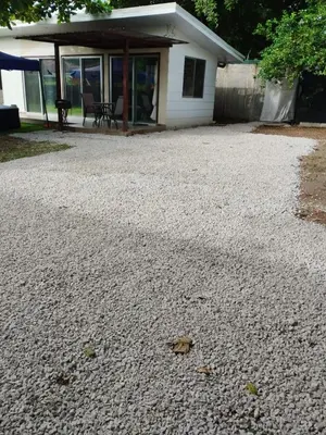 a gravel driveway in front of a house at Casa espejo in Potrero