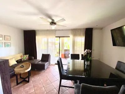a living room with a couch and a table at Modern Condo with a Rooftop Patio in Liberia