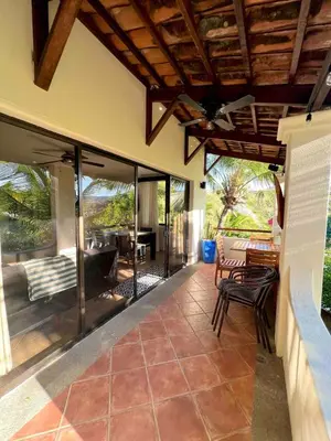an open patio with chairs and tables on a house at Stylish & Comfortable Condo with Balconies in Liberia