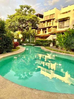 a swimming pool in front of a building at Stylish & Comfortable Condo with Balconies in Liberia