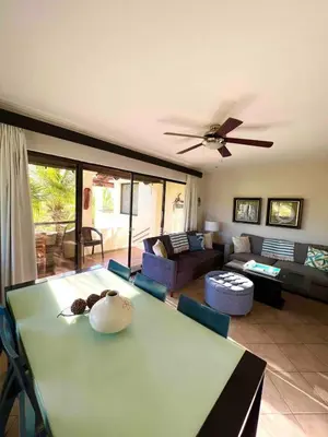 a living room with a table and a couch at Stylish & Comfortable Condo with Balconies in Liberia