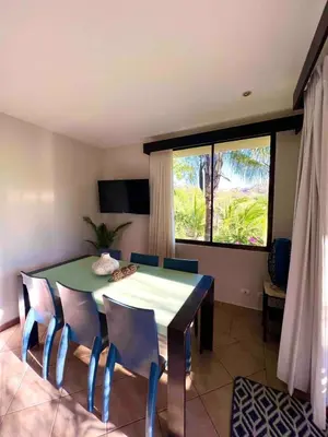 a dining room with a green table and chairs at Stylish & Comfortable Condo with Balconies in Liberia