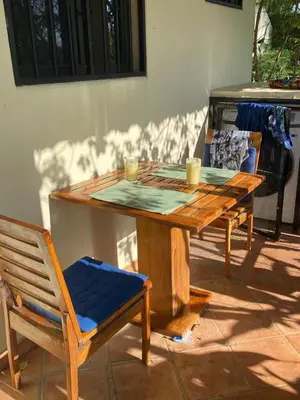 a wooden table with two cups on top of it at Turtle's Nest Condo in Liberia