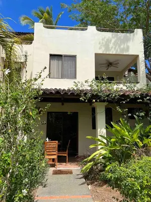 a house with a chair in front of it at Turtle's Nest Condo in Liberia