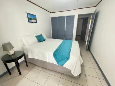 a small bedroom with a bed and a table at 3 Min from SJO airport Kaeli in Alajuela City
