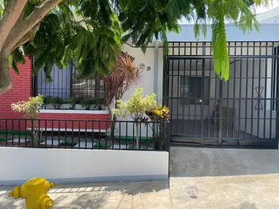 a yellow fire hydrant in front of a house at 3 Min from SJO airport Kaeli in Alajuela City