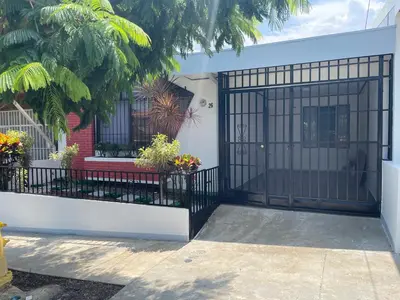 a gate to a house with flowers and plants at 3 Min from SJO airport Kaeli in Alajuela City