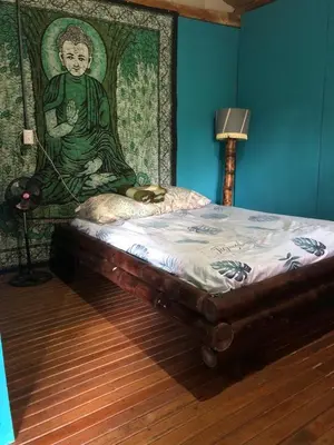 a bed in a room with a painting on the wall at Finca Bambú Del Valle in Santa Clara