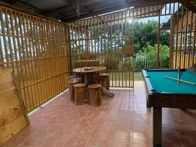 a room with a pool table and stools at Cabaña Mamá Elia in Trinidad