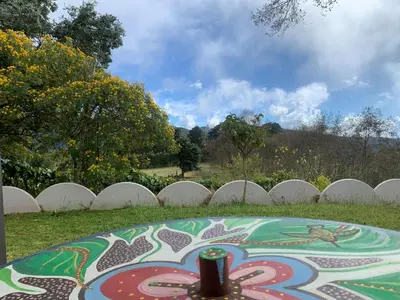 a table in front of a white picket fence at Cabaña Mamá Elia in Trinidad