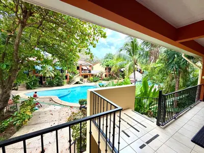 a view of the pool from the balcony of a house at Cocomarindo Breeze Condo and Amazing Pool in Coco