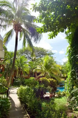 a resort with palm trees and a swimming pool at Cocomarindo Breeze Condo and Amazing Pool in Coco