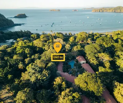 an overhead view of a road with a yellow street sign at Cocomarindo Breeze Condo and Amazing Pool in Coco