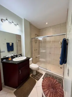 a bathroom with a shower and a sink and a toilet at Oceanview Rancho with Two bedroom & Two baths in Coco
