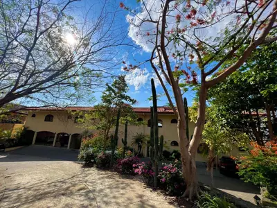 a building with trees and flowers in front of it at Oceanview Rancho with Two bedroom & Two baths in Coco