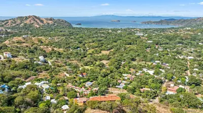 an aerial view of a village on a hill with the ocean at Casa Blanca Two Bedroom,Two Bath Oceanview Condo in Coco