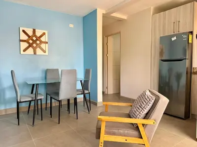 a living room with a table and chairs at Sunny Tropical condo and rooftop terrace in Coco