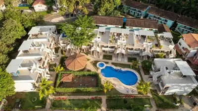an aerial view of a large house with a swimming pool at Sunny Tropical condo and rooftop terrace in Coco