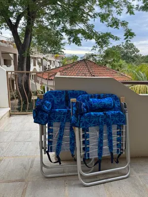 a cart filled with blue padding sitting on a porch at Sunny Tropical condo and rooftop terrace in Coco