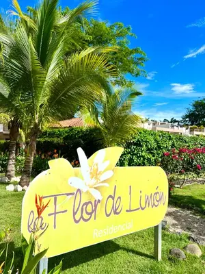 a sign for a flor de lunch in front of a palm tree at Coco Dream Escapes Ground unit in Coco