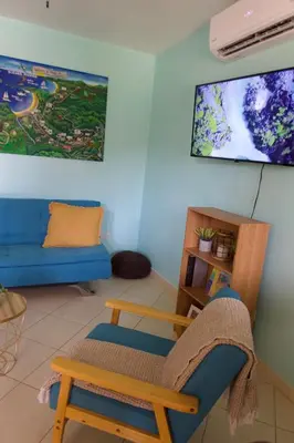 a living room with a blue couch and a blue chair at Coco Dream Escapes Ground unit in Coco