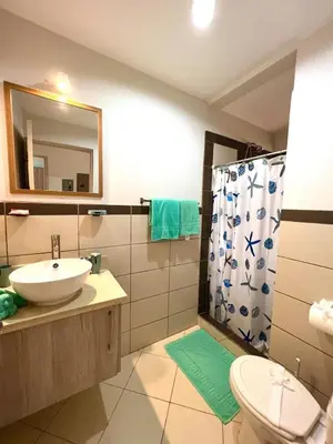 a bathroom with a sink and a toilet and a shower at Ocean Breeze Condo in Coco