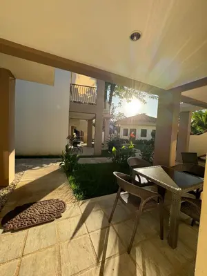 a patio with a table and chairs in a yard at Ocean Breeze Condo in Coco