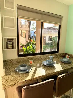 a kitchen with a table with two bowls and a window at Ocean Breeze Condo in Coco