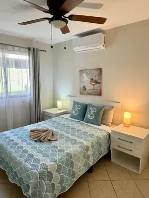 a bedroom with a bed and a ceiling fan at High Tide 2 bed1 bath condo Terrace in Coco