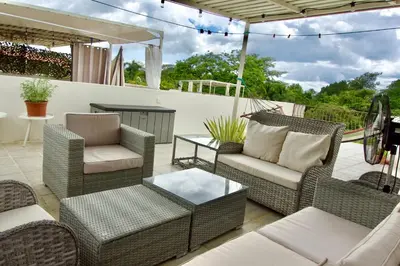 a patio with wicker chairs and a table at High Tide 2 bed1 bath condo Terrace in Coco