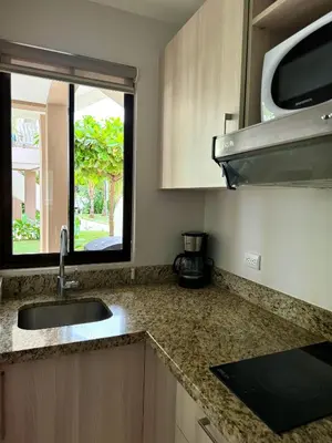 a kitchen counter with a sink and a window at EndlessSummer Beach Escape in Coco